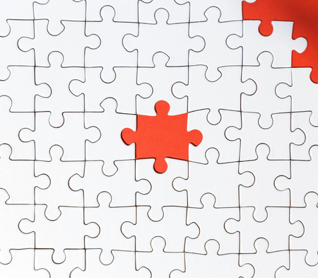 Background of white puzzle with a bright res puzzle centerの写真素材