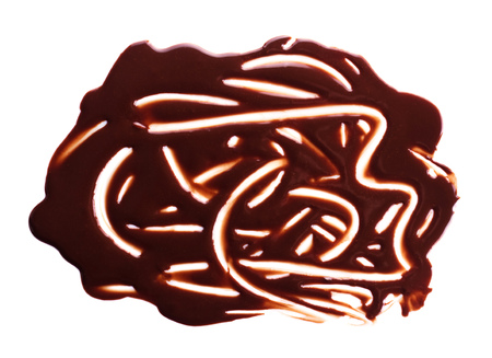 Chocolate drips. Melted chocolate on the surface, the patterns isolated on white backgroundの写真素材