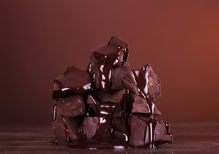 Pieces of flavored chocolate molten glaze on a dark backgroundの写真素材