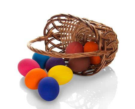 Bright Easter Sunday. Basket with colorful painted eggs isolated on white backgroundの写真素材