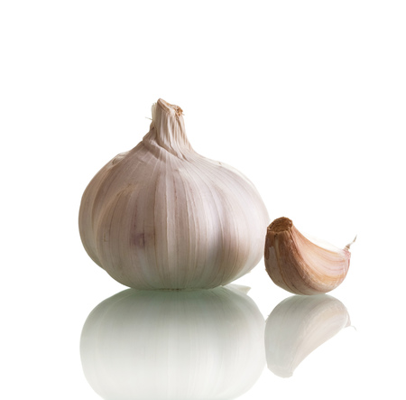 Head fresh garlic and one clove isolated on white backgroundの写真素材