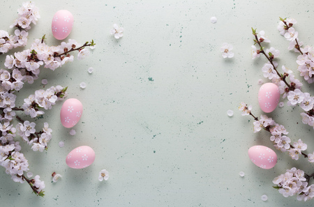 Easter composition in the high key of the flowering branches of apricot and pink Easter eggsの写真素材