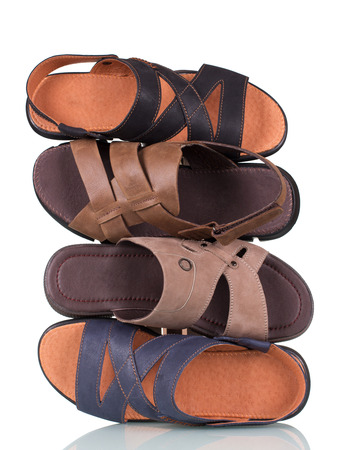 Stack of men's summer sandals isolated on white backgroundの写真素材