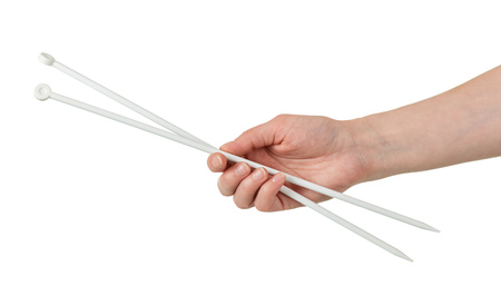 Female hand with long needles for knitting isolated on white backgroundの写真素材