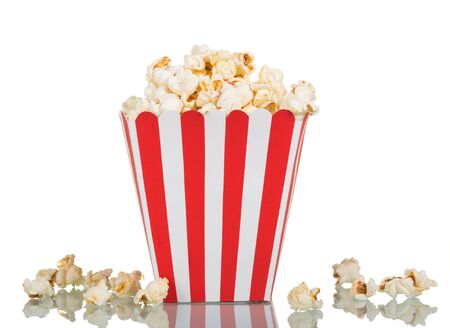 Popcorn in a large square box and near isolated on white background.の写真素材