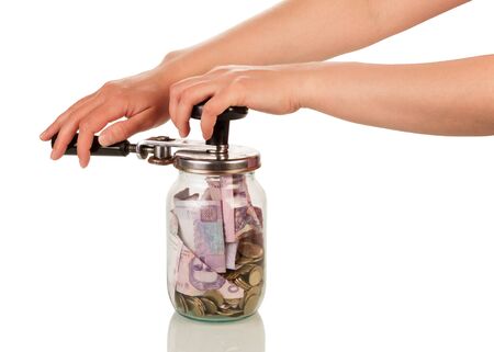 Female hands close jar with money isolated on white backgroundの写真素材