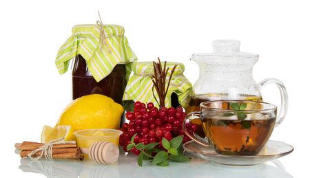 Jam hot tea with honey and lemon, viburnum berries and cinnamon, isolated on white backgroundの写真素材