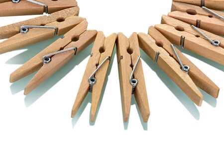 Many wooden clothespins, nicely laid out, isolated on white backgroundの写真素材