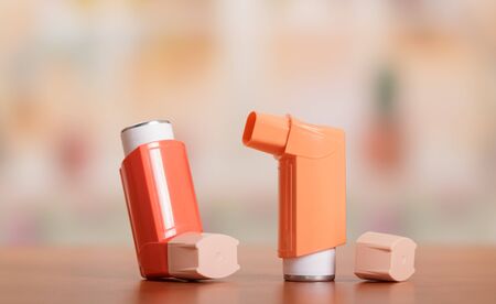 Two small pocket inhaler to relieve an asthma attack, located on tableの写真素材