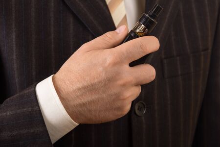 Electronic cigarette for wicking in the hands of businessmanの写真素材