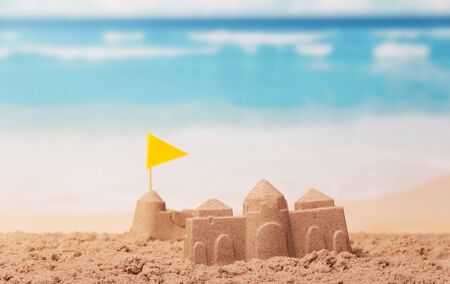The palaces of sand, a yellow flag on the beach.の写真素材