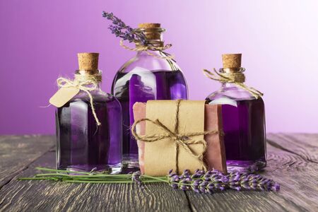 Bottles with lavender tincture closed cork, and piece of soap on old wooden tableの写真素材