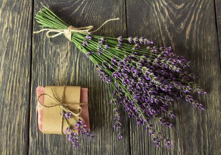 Handmade soap wrapped in paper, near on gray surface bunch of lavenderの写真素材