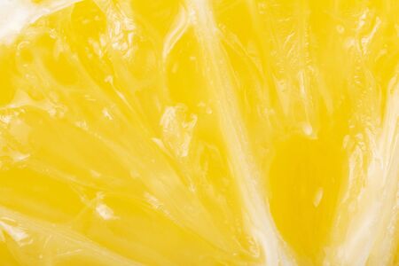 Cross section of bright yellow lemon, depicted close-upの写真素材