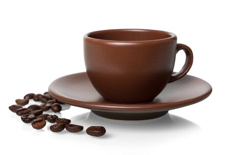 Ceramic Cup and saucer for hot drink, coffee beans near, isolated on white backgroundの写真素材