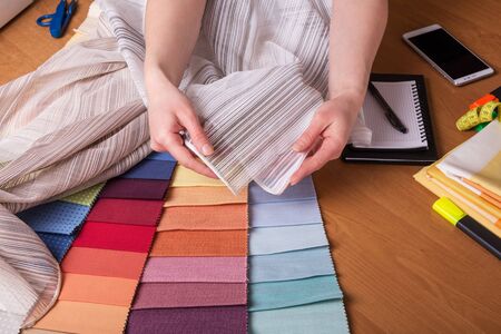 Large selection of fabric samples for interior decoration on work tableの写真素材