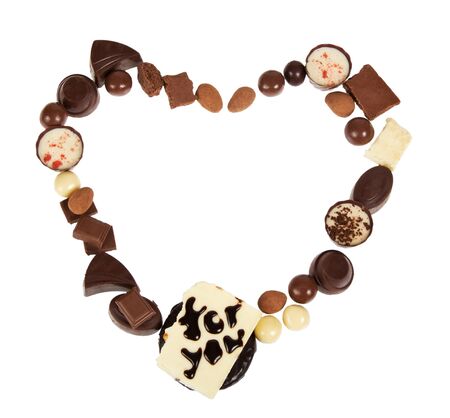 Chocolate, assorted, praline candies, almonds lined in heart shape, isolated on white backgroundの写真素材
