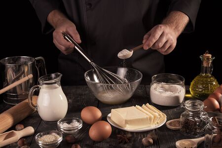 Set of products and process of kneading dough for baking, isolated on black backgroundの写真素材