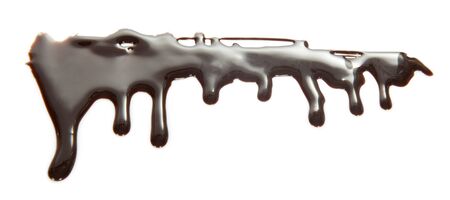 Flows of melted chocolate of bizarre shape isolated on white backgroundの写真素材