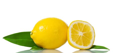 Bright yellow lemon with green leaves and piece of fruit isolated on white backgroundの写真素材