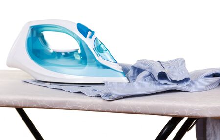 Electric iron and clean linen on Ironing Board isolated on white backgroundの写真素材