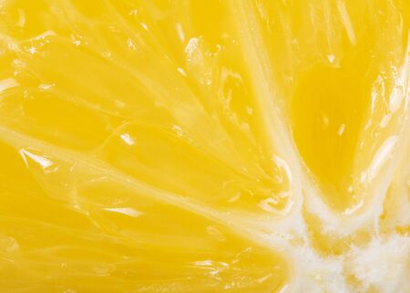 Bright yellow cross-section of juicy lemon, depicted close-up. Backgroundの写真素材
