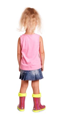Little blonde girl standing in rubber boots isolated on white backgroundの写真素材