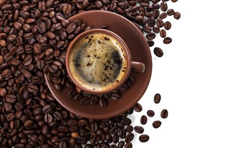 Cup of freshly brewed coffee on pile of coffee beans isolated on white backgroundの写真素材