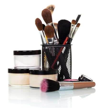 Cosmetic brushes, jars with creams and blush isolated on white background.の写真素材