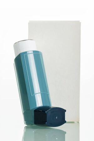 Asthma inhaler and a box isolated on a white background.の写真素材
