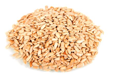 A pile of peeled fried sunflower seeds isolated on white background.の写真素材