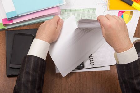 Office table with folders, documents and reportsの写真素材