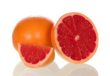 Bright juicy grapefruit and slice isolated on white backgroundの写真素材