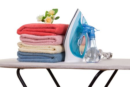 Bright terry towels and iron with spray gun, isolated on white backgroundの写真素材