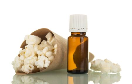 Package with popcorn and bottle with aromatic liquid for smoking isolated on white backgroundの写真素材