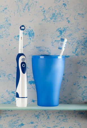 Electric appliance and toothbrush for oral hygiene, on glass shelfの写真素材