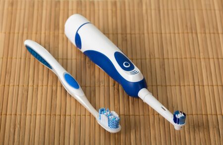 Two brushes for hygienic care of the oral cavity on beige matの写真素材