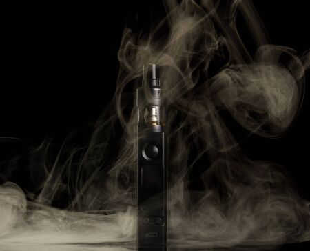 Vaping. Couples from an electronic cigarette isolated on black backgroundの写真素材