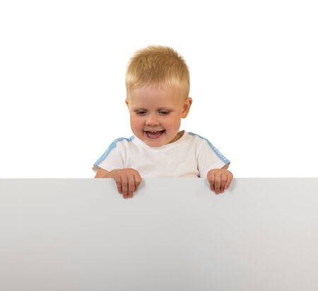 Laughing little boy holding a banner, isolated on white backgroundの写真素材