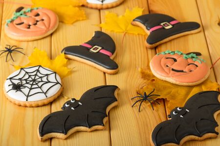 Halloween. Bright sweet gingerbread cookies on wooden backgroundの写真素材