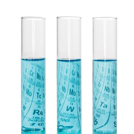 Three test tubes with blue liquids and a sheet of paper with Mendeleev's table isolated on white background.の写真素材
