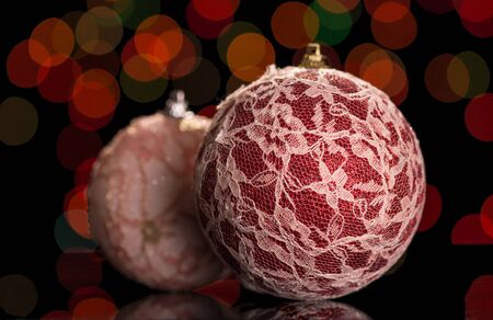 Red balls with lace on a dark flickering backgroundの写真素材