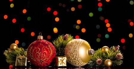 Large and small decorative balls, pine branches, small gift boxes, on a flickering backgroundの写真素材