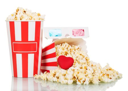 Most full popcorn box with an average of scattered snack with hearts and 3d glasses isolated on white backgroundの写真素材
