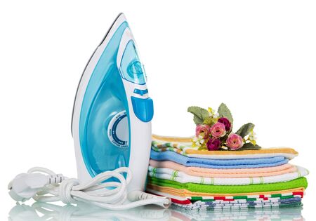 Electric iron and ironing things with a flower isolated on white backgroundの写真素材