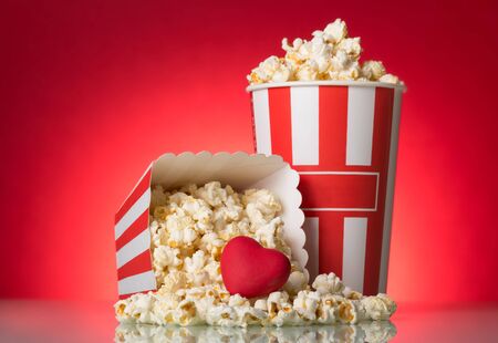 Large box and sprinkled snack, heart on a bright red backgroundの写真素材