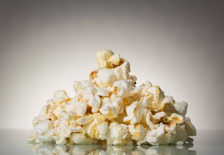 Pieces of salty popcorn on a gray backgroundの写真素材