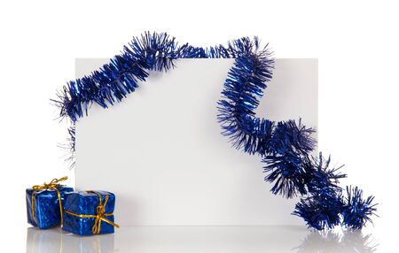 White Christmas card decorated with blue tinsel and gifts isolated on white backgroundの写真素材