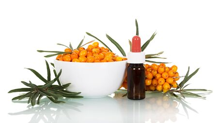 Sea-buckthorn oil and fresh berries with leaves isolated on white backgroundの写真素材