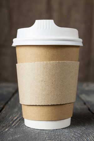Cup-Wok for hot coffee to take away, on background of old wooden surfaceの写真素材